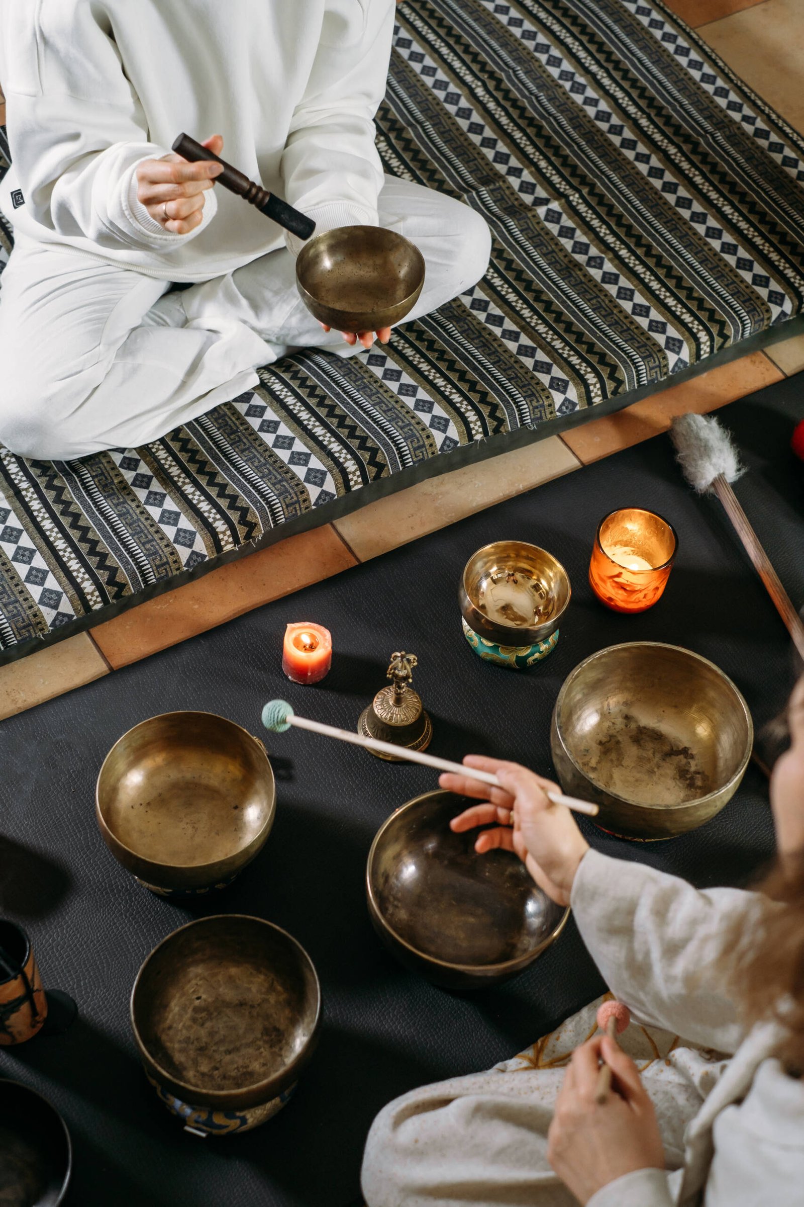 Singing bowls top view, sound healing alternative therapy. Overhead view Singing bowls top view, sound healing alternative therapy. Woman playing on percussion metal music instruments. Mental health care with meditation, relaxation yoga massage